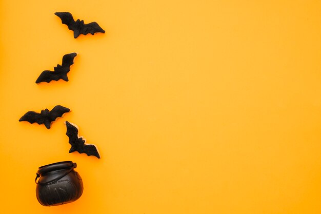 Halloween composition with bats and tea pot