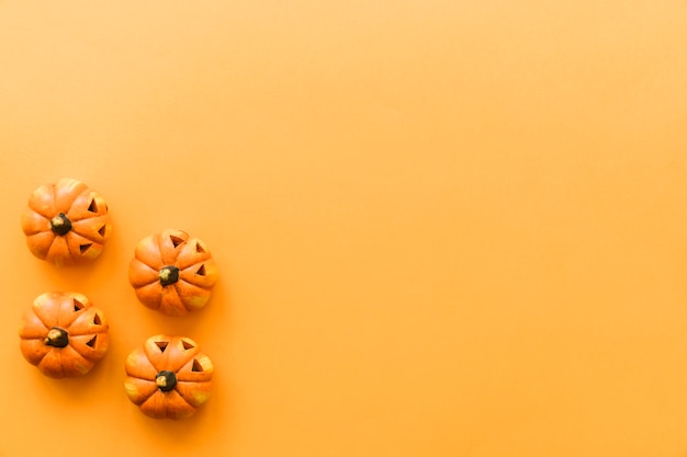 Halloween composition with four pumpkins and space