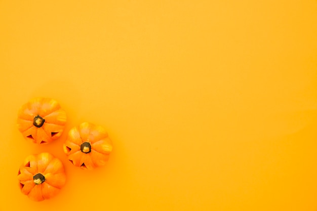 Free photo halloween composition with three pumpkins and space