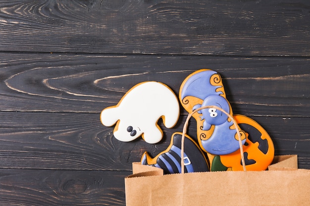 Halloween cookies in paper bag on table