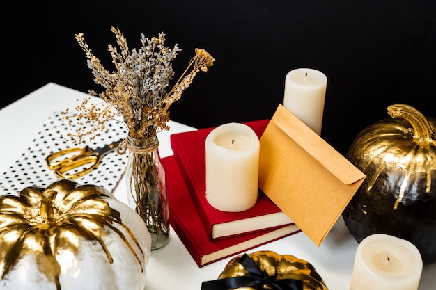 Halloween decor on white table over black surface