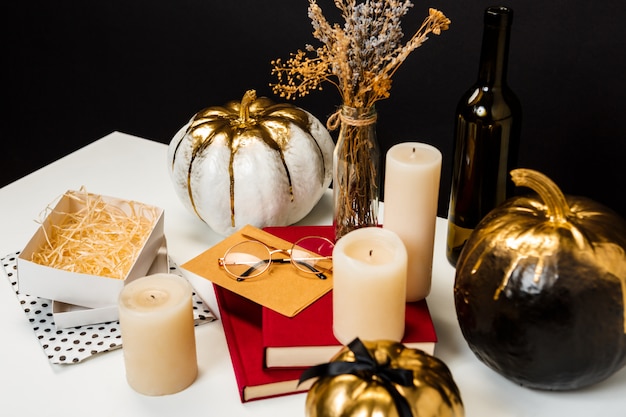 Halloween decor on white table over black surface