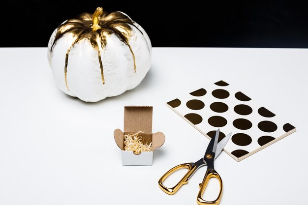 Halloween decor on white table over black surface