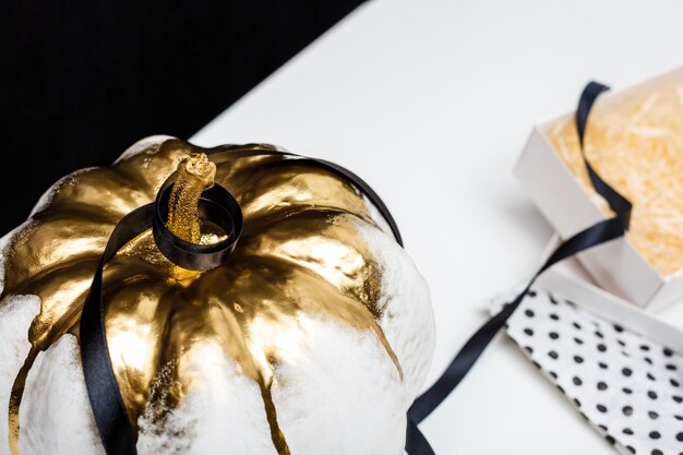 Halloween decor on white table over black surface