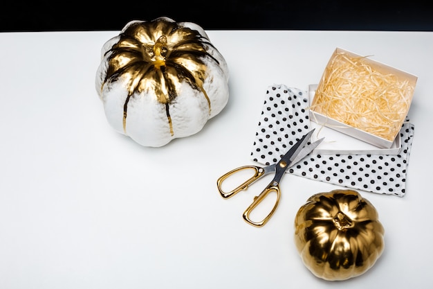 Halloween decor on white table over black surface