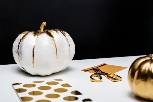 Halloween decor on white table over black surface