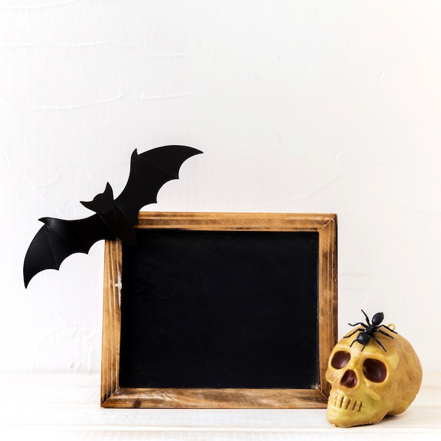 Free photo halloween decorations near chalkboard