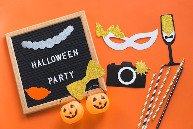 Halloween decorations near frame with writing