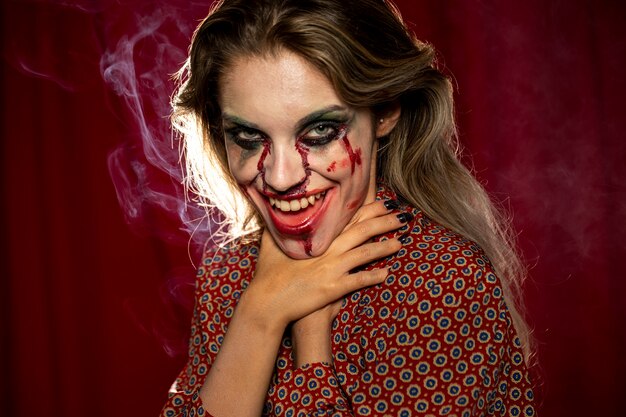 Halloween female model choking with her own hands photo shooting