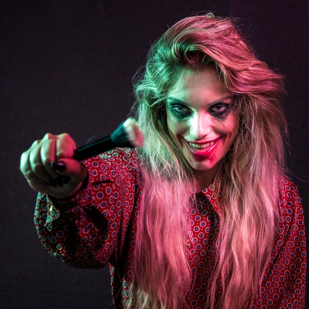 Halloween female model holding a powder brush