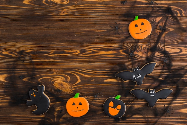 Halloween gingerbreads arranged on wood background