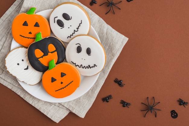 Halloween gingerbreads on dish placed on linen cloth