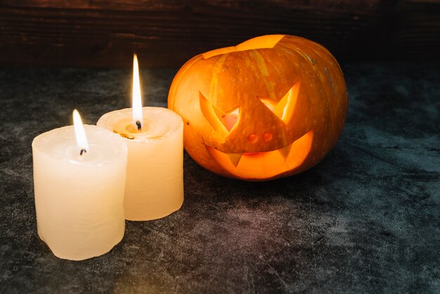 Halloween glowing pumpkin and candles