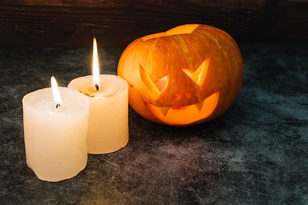 Halloween glowing pumpkin and candles