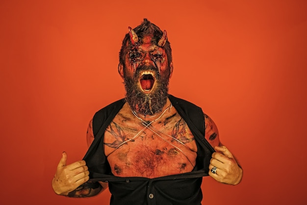 Halloween man devil rip shirt with anger on orange background