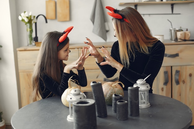 Halloween. Mother and daughter in halloween costume. Family at home.