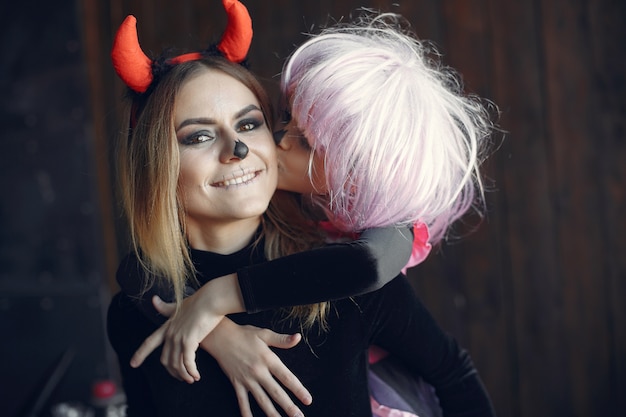 Free photo halloween. mother and daughter in halloween costume. family at home.