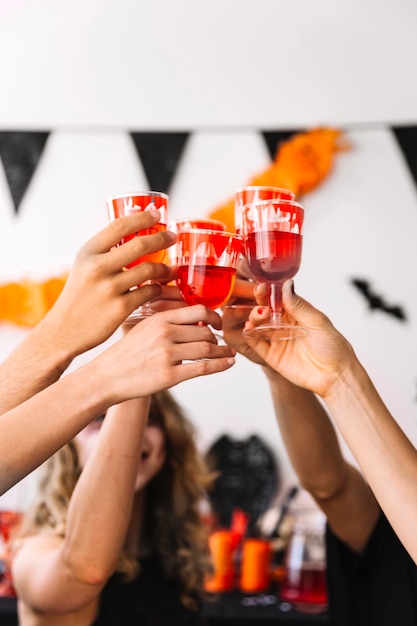 Halloween party with red drinks in glasses