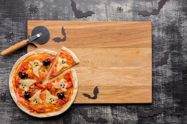 Halloween pizza slices on wooden board