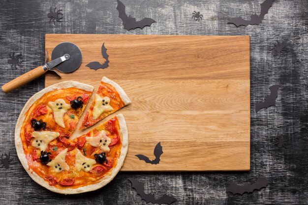 Halloween pizza slices on wooden board