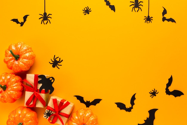 Halloween pumpkins with gifts and spiders