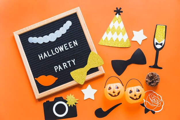 Halloween stickers and buckets near frame with writing