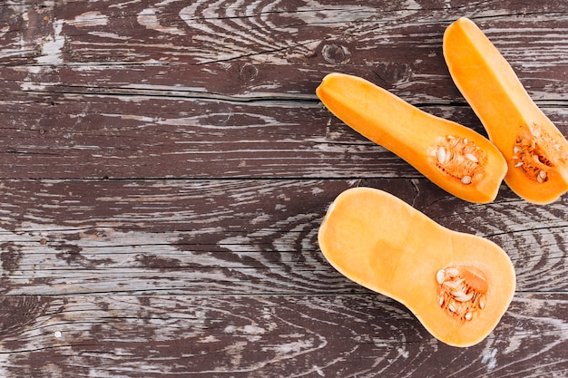 Halved butternut squash on an old wooden surface