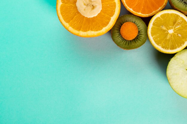 Halved fruits on a blue table