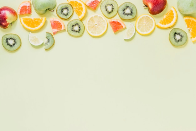 Free photo halves of apples near cut fruits