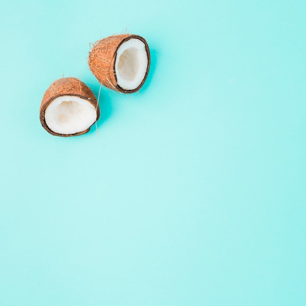 Halves of cracked coconut with white ripe pulp 