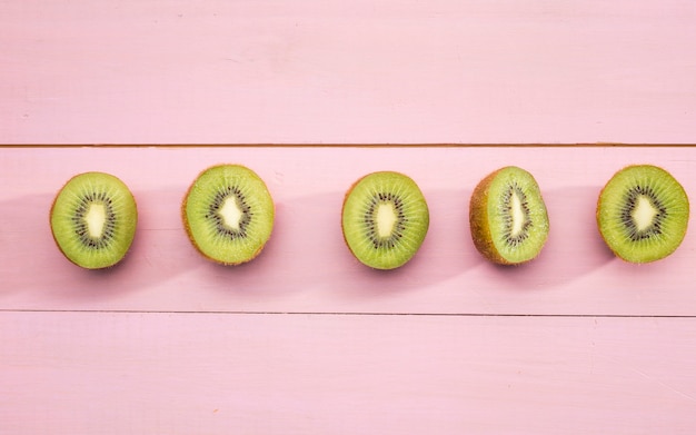 Metà di kiwi su fondo rosa