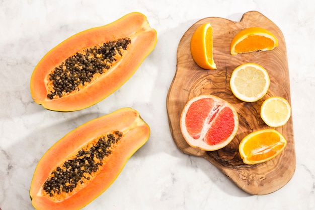 Halves of papaya and citrus fruits