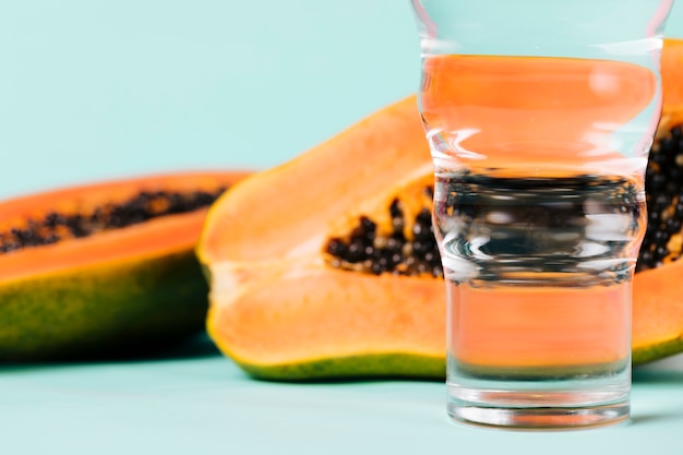 Halves of papaya fruit and water