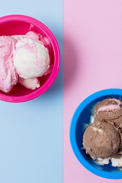 Halves of pink and blue bowls filled with ice cream