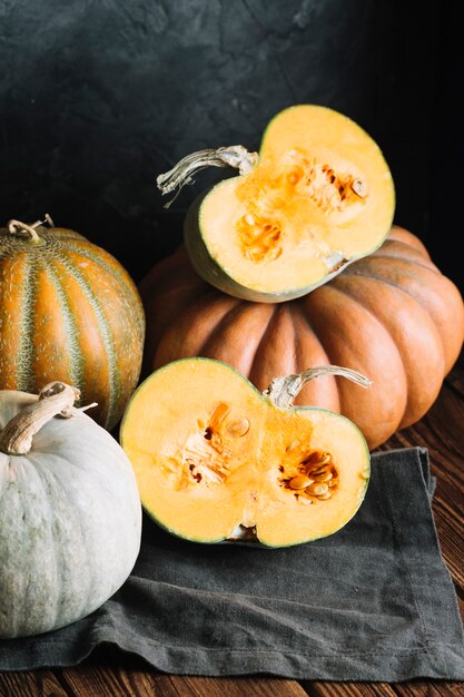 Halves of ripe pumpkin on a black cloth