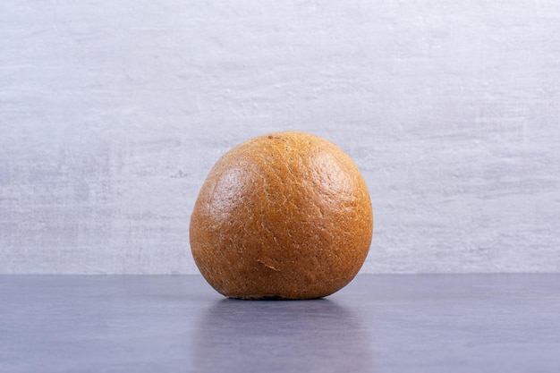 Free photo hamburger bun standing upright on marble background. high quality photo