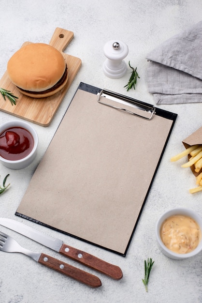 Hamburger and fries served on table