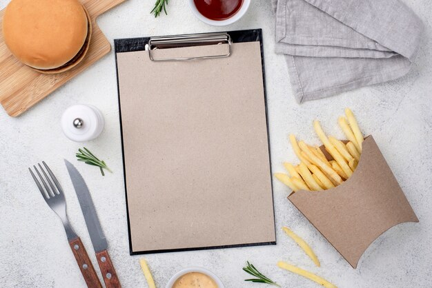 Hamburger and fries with clipboard