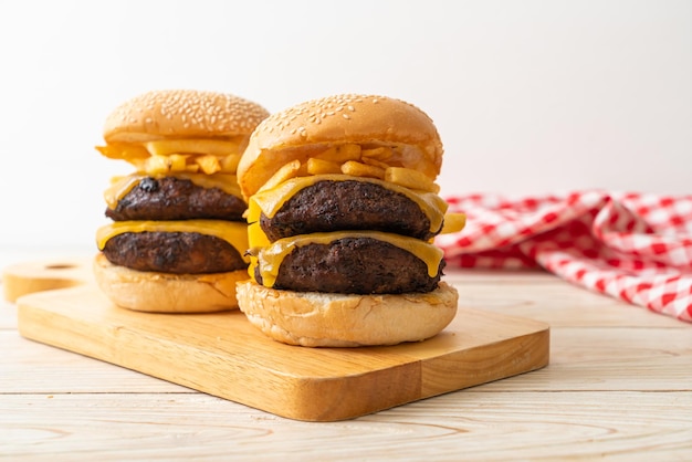 Гамбургер или бургеры из говядины с сыром и картофелем фри - нездоровый стиль питания