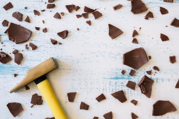 Hammer near pieces of chocolate