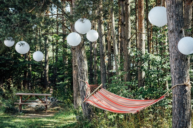 Hammock on trees with white balloon decorations