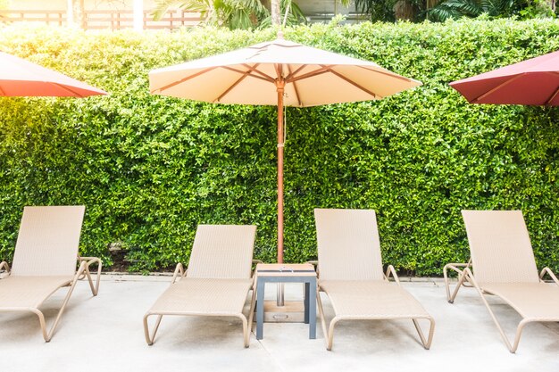 Hammocks and umbrellas in a plants background