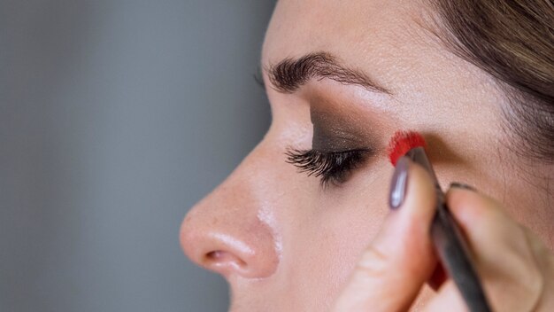 Hand applying make up on client