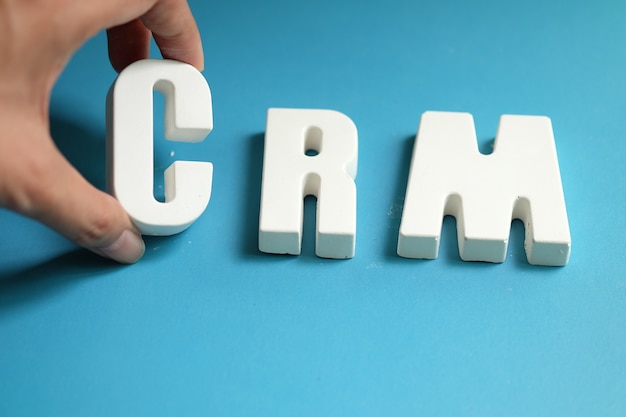 Free Photo hand arrange white letters as crm