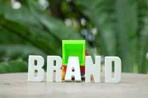 Free photo hand arrange white letters brand