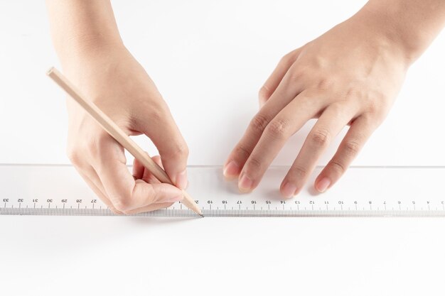 Hand of businesswoman writing on paper in the office