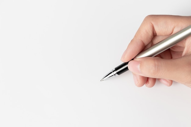 Hand of businesswoman writing on paper in the office