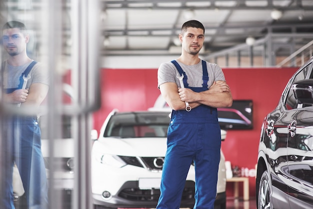 Hand of car mechanic with wrench.