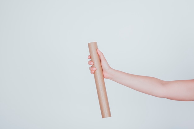 Hand and cardboard tube