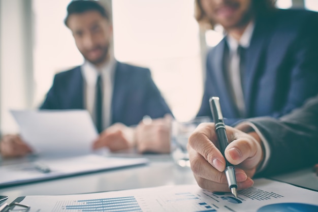 Hand close-up of an executive reviewing a chart